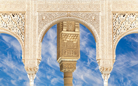 Arches in Islam (Moorish) style (against the background of a beautiful sky with clouds) in Alhambra, Granada, Spainの写真素材
