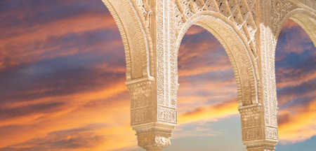 Arches in Islam (Moorish) style (against the sunset) in Alhambra, Granada, Spainの写真素材