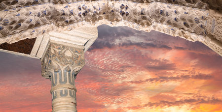 Arches in Islam (Moorish) style (against the sunset) in Alhambra, Granada, Spain