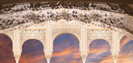 Arches in Islam (Moorish) style (against the sunset) in Alhambra, Granada, Spain