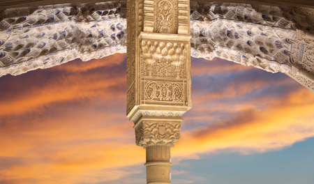 Arches in Islam (Moorish) style (against the sunset) in Alhambra, Granada, Spain
