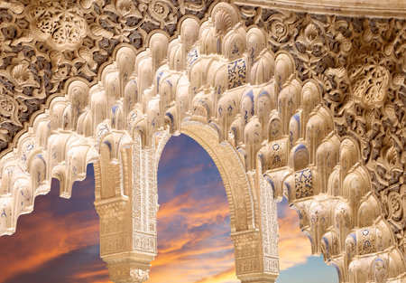 Arches in Islam (Moorish) style (against the sunset) in Alhambra, Granada, Spain