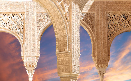 Arches in Islam (Moorish) style (against the sunset) in Alhambra, Granada, Spain
