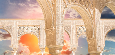 Arches in Islam (Moorish) style (against the sunset) in Alhambra, Granada, Spain