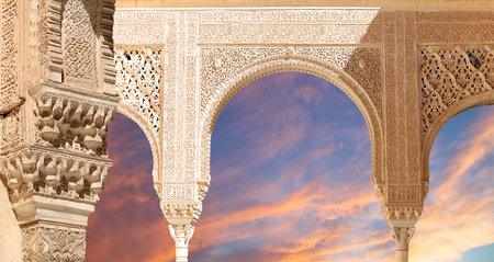 Arches in Islam (Moorish) style (against the sunset) in Alhambra, Granada, Spain