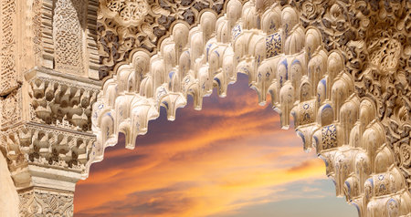 Arches in Islam (Moorish) style (against the sunset) in Alhambra, Granada, Spain