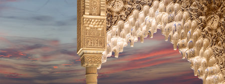 Arches in Islam (Moorish) style (against the sunset) in Alhambra, Granada, Spain
