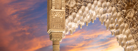 Arches in Islam (Moorish) style (against the sunset) in Alhambra, Granada, Spain