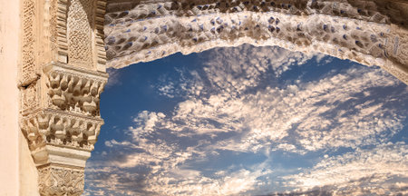 Arches in Islam (Moorish) style (against the background of a beautiful evening sky with clouds) in...