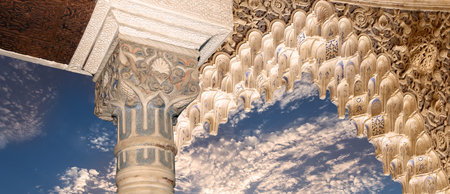 Arches in Islam (Moorish) style (against the background of a beautiful evening sky with clouds) in...