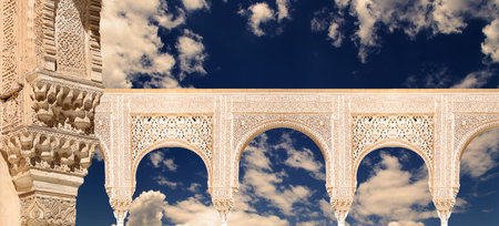 Arches in Islam (Moorish) style (against the background of a beautiful evening sky with clouds) in...