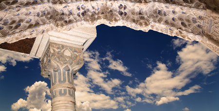Arches in Islam (Moorish) style (against the background of a beautiful evening sky with clouds) in...