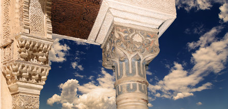 Arches in Islam (Moorish) style (against the background of a beautiful evening sky with clouds) in...