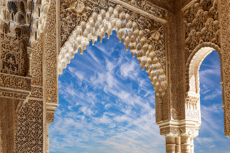 Arches in Islamic (Moorish) style (against the background of a beautiful sky with clouds) in...