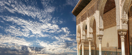 Arches in Islamic (Moorish) style (against the background of a beautiful sky with clouds) in...