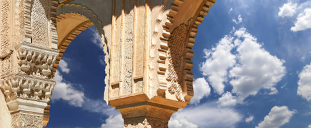 Arches in Islamic (Moorish) style (against the background of a beautiful sky with clouds) in...
