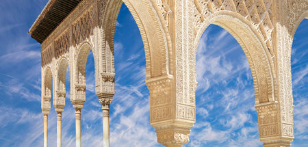 Arches in Islamic (Moorish) style (against the background of a beautiful sky with clouds) in...
