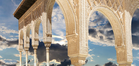 Arches in Islamic (Moorish) style (against the background of a beautiful sky with clouds) in...