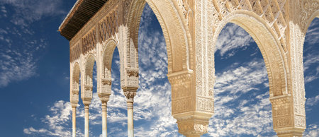 Arches in Islamic (Moorish) style (against the background of a beautiful sky with clouds) in...