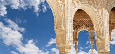 Arches in Islamic (Moorish) style (against the background of a beautiful sky with clouds) in...