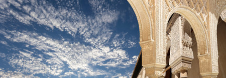 Arches in Islamic (Moorish) style (against the background of a beautiful sky with clouds) in...