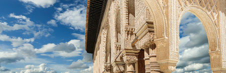 Arches in Islamic (Moorish) style (against the background of a beautiful sky with clouds) in...