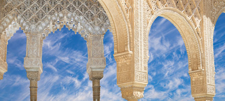 Arches in Islamic (Moorish) style (against the background of a beautiful sky with clouds) in...