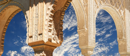 Arches in Islamic (Moorish) style (against the background of a beautiful sky with clouds) in...