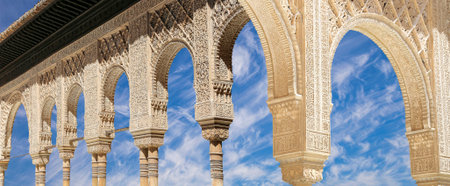 Arches in Islamic (Moorish) style (against the background of a beautiful sky with clouds) in...