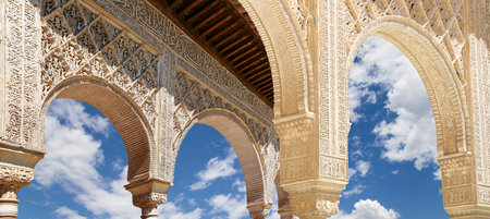 Arches in Islamic (Moorish) style (against the background of a beautiful sky with clouds) in...