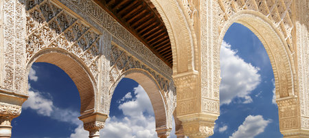 Arches in Islamic (Moorish) style (against the background of a beautiful sky with clouds) in...
