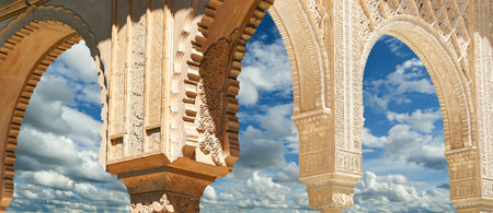 Arches in Islamic (Moorish) style (against the background of a beautiful sky with clouds) in...