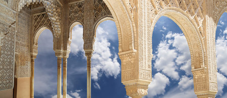 Arches in Islamic (Moorish) style (against the background of a beautiful sky with clouds) in...