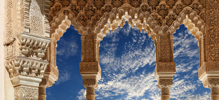 Arches in Islamic (Moorish) style (against the background of a beautiful sky with clouds) in...