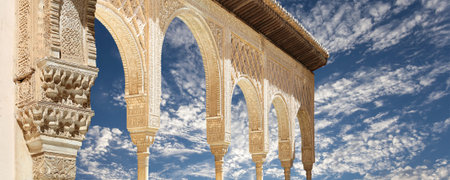 Arches in Islamic (Moorish) style (against the background of a beautiful sky with clouds) in...