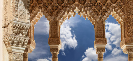 Arches in Islamic (Moorish) style (against the background of a beautiful sky with clouds) in...