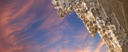 Arches in Islamic (Moorish) style (against the sunset) in Alhambra, Granada, Spainの写真素材