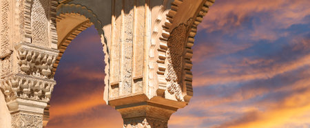Arches in Islamic (Moorish) style (against the sunset) in Alhambra, Granada, Spain