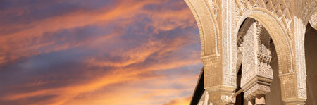 Arches in Islamic (Moorish) style (against the sunset) in Alhambra, Granada, Spainの写真素材