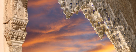 Arches in Islamic (Moorish) style (against the sunset) in Alhambra, Granada, Spain