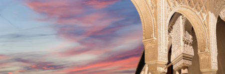 Arches in Islamic (Moorish) style (against the sunset) in Alhambra, Granada, Spainの写真素材
