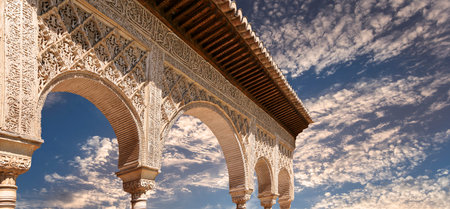 Arches in Islamic (Moorish) style (against the sunset) in Alhambra, Granada, Spain