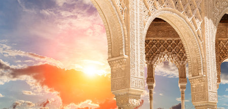Arches in Islamic (Moorish) style (against the sunset) in Alhambra, Granada, Spainの写真素材