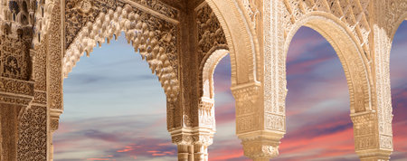 Arches in Islamic (Moorish) style (against the sunset) in Alhambra, Granada, Spain