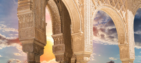 Arches in Islamic (Moorish) style (against the sunset) in Alhambra, Granada, Spain