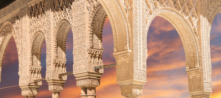 Arches in Islamic (Moorish) style (against the sunset) in Alhambra, Granada, Spain