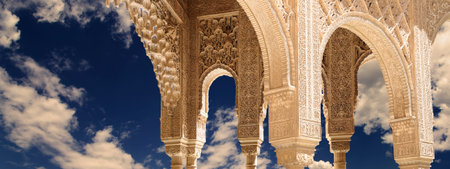 Arches in Islamic (Moorish) style (against the background of a beautiful evening sky with clouds) in...