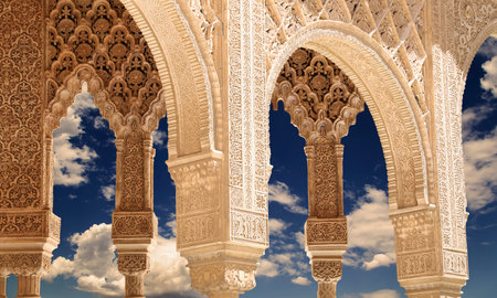 Arches in Islamic (Moorish) style (against the background of a beautiful evening sky with clouds) in...