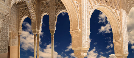 Arches in Islamic (Moorish) style (against the background of a beautiful evening sky with clouds) in...