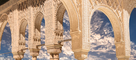 Arches in Islamic (Moorish) style (against the background of a beautiful evening sky with clouds) in...